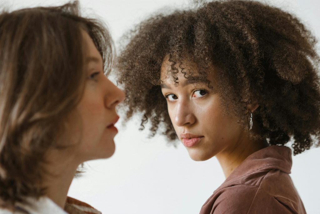 Engaging portrait showcasing diversity with two women, focusing on natural beauty.
